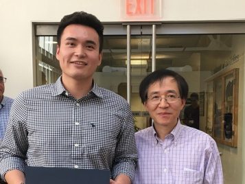 Professor Xuming He awarding Wei Jiang an Outstanding first year Master's student award for the 2015-2016 academic year 